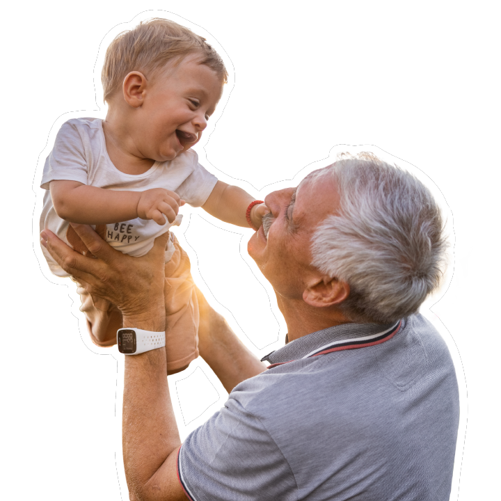 grandpa holding up a grandson in the air both smiling